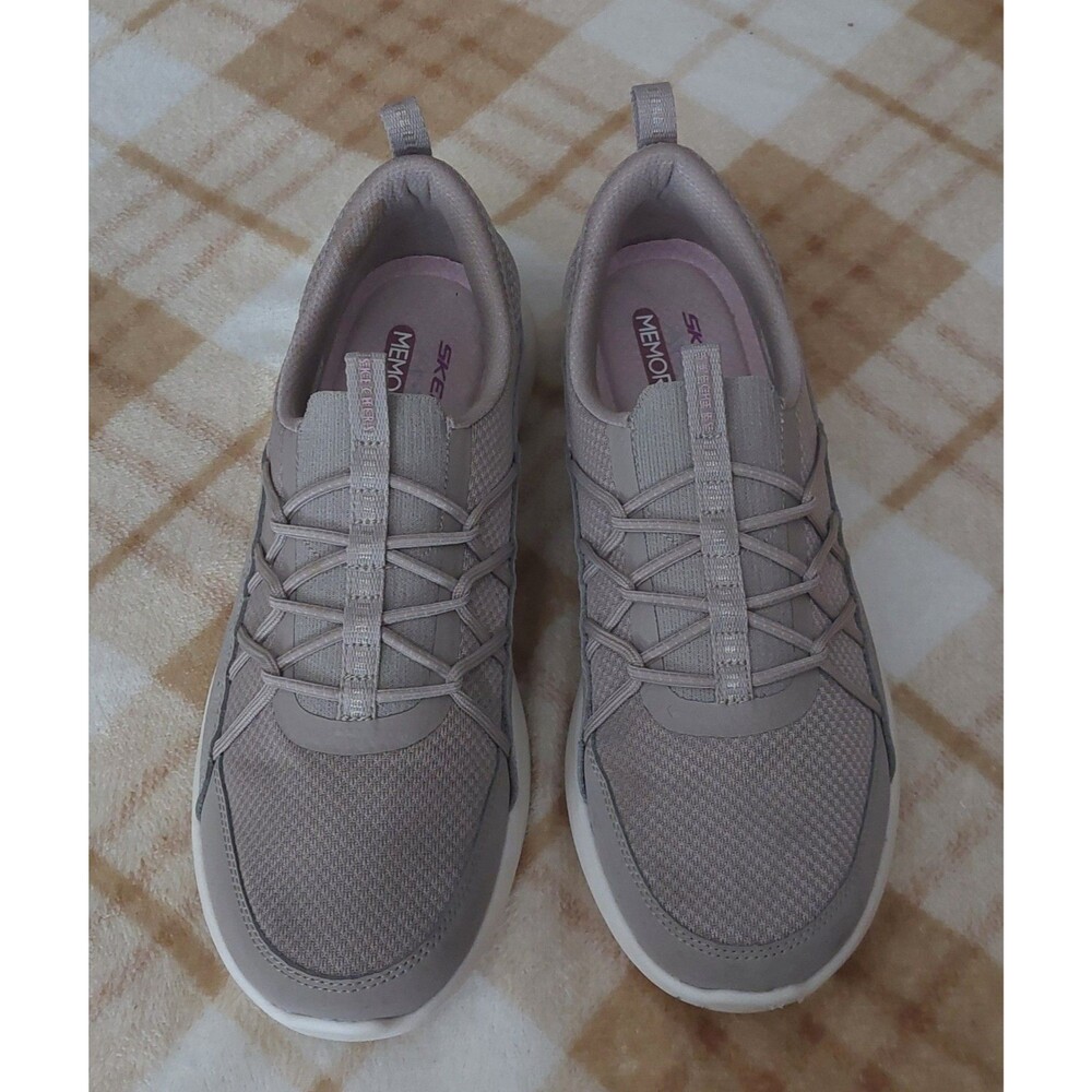Skechers slip-on sneakers featuring a breathable mesh upper and convenient...
